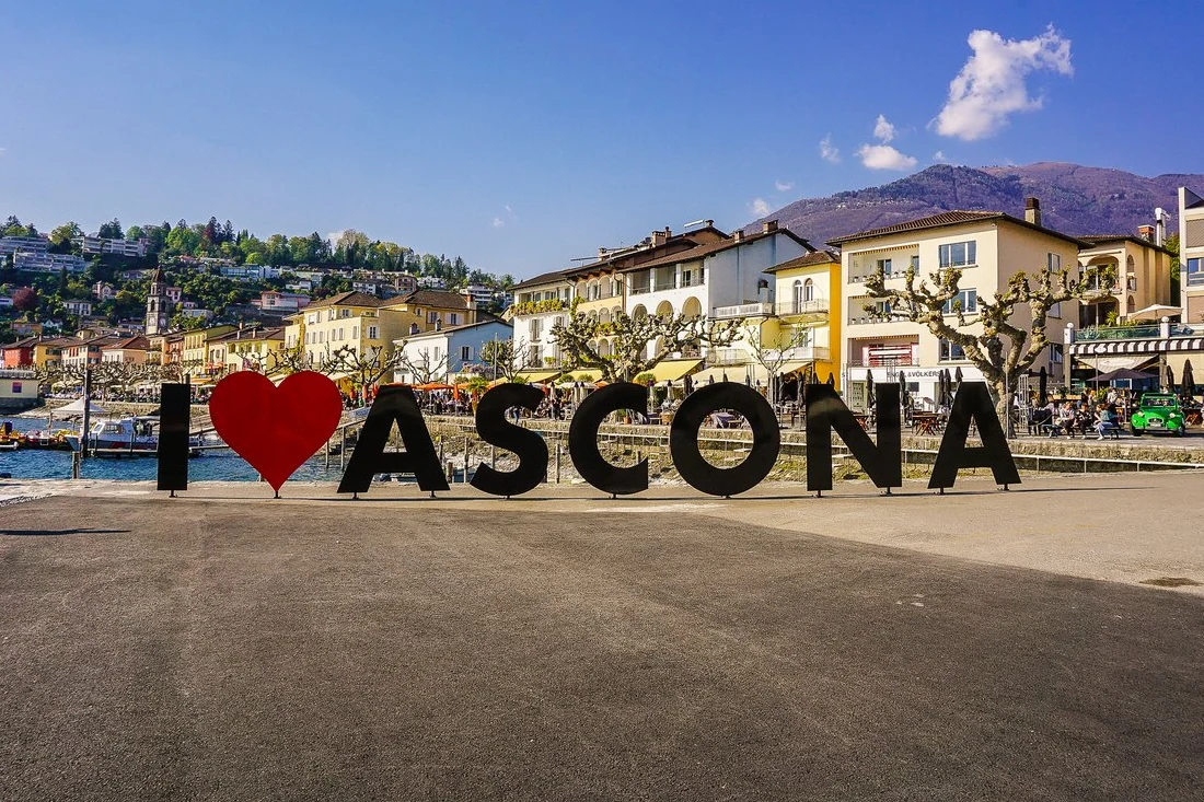 Ascona promenade with colourful facades, harbour and the historic church tower