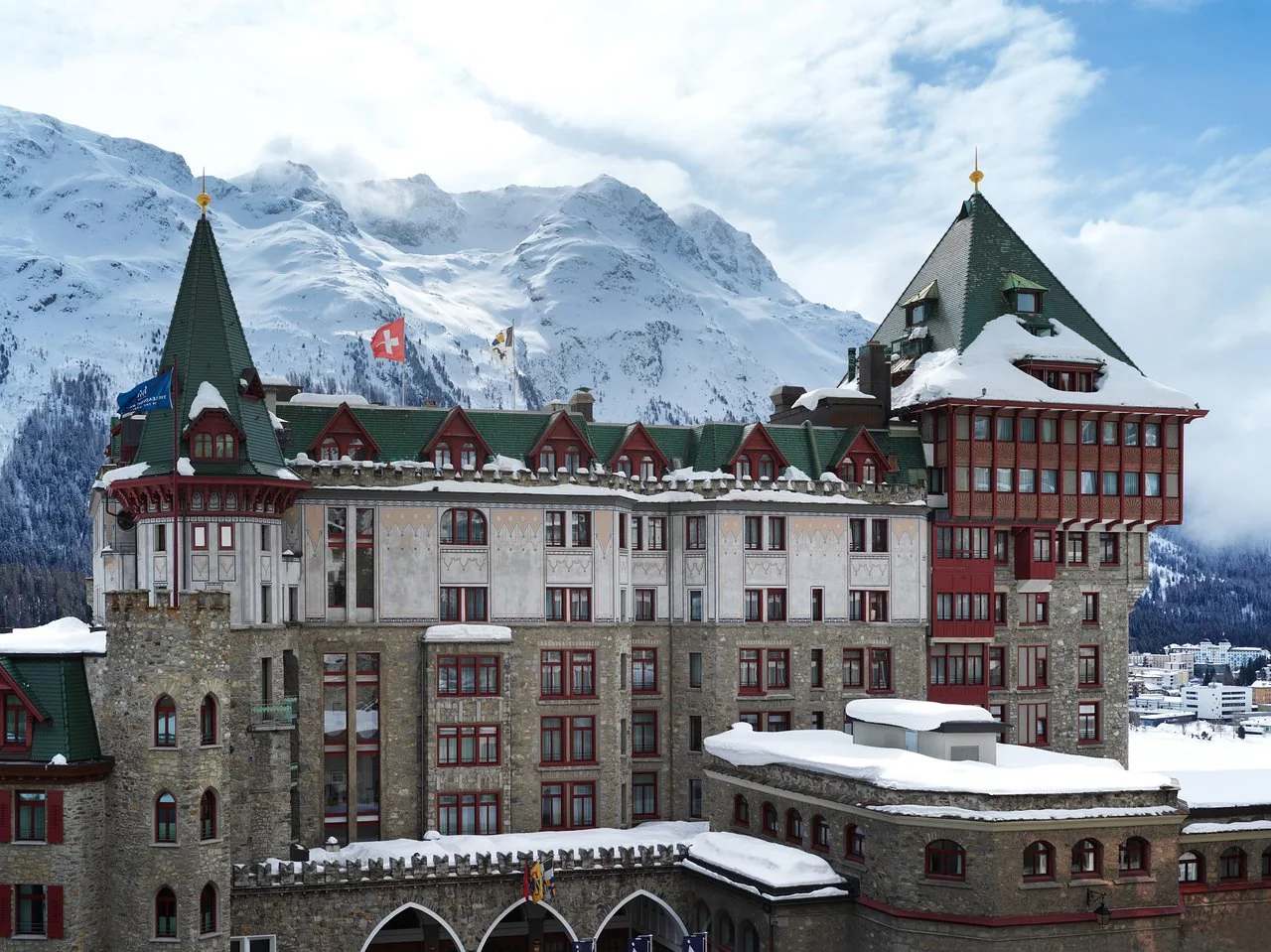 Badrutt's Palace in St. Moritz surrounded by the snow-covered Engadin mountains