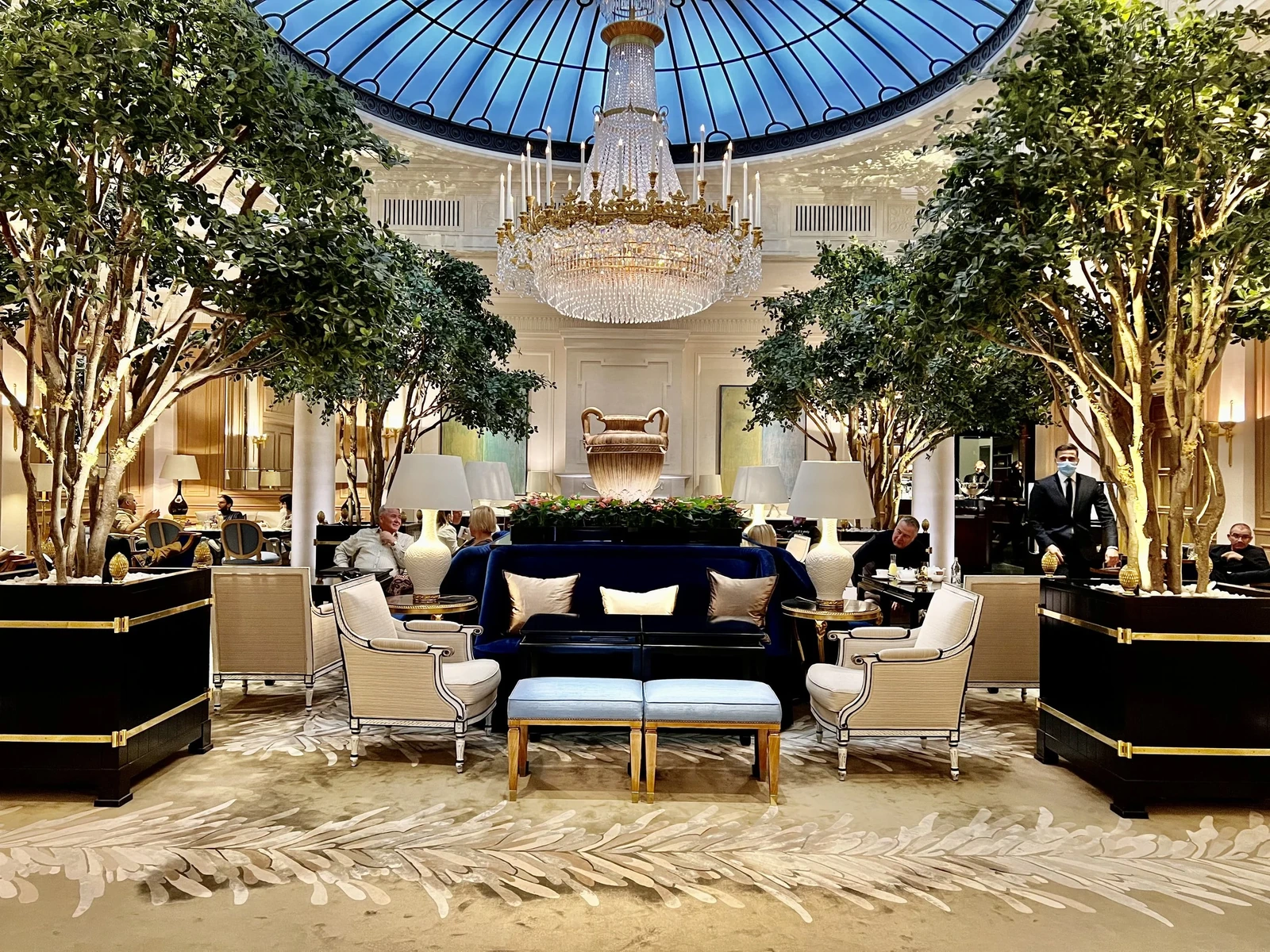 Elegant interior at Baur au Lac with chandelier, indoor greenery and seating