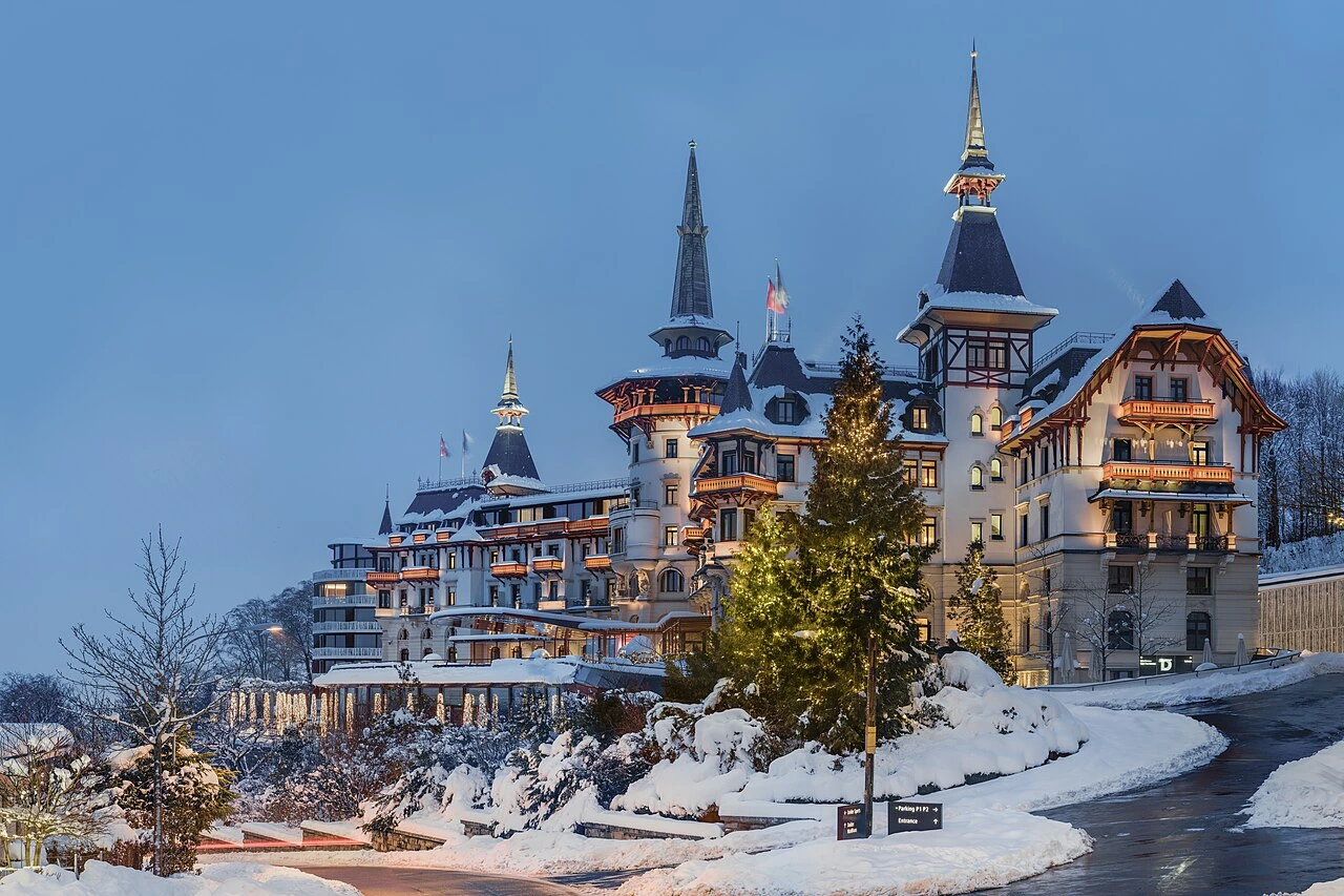 The Dolder Grand illuminated in its winter setting above Zurich
