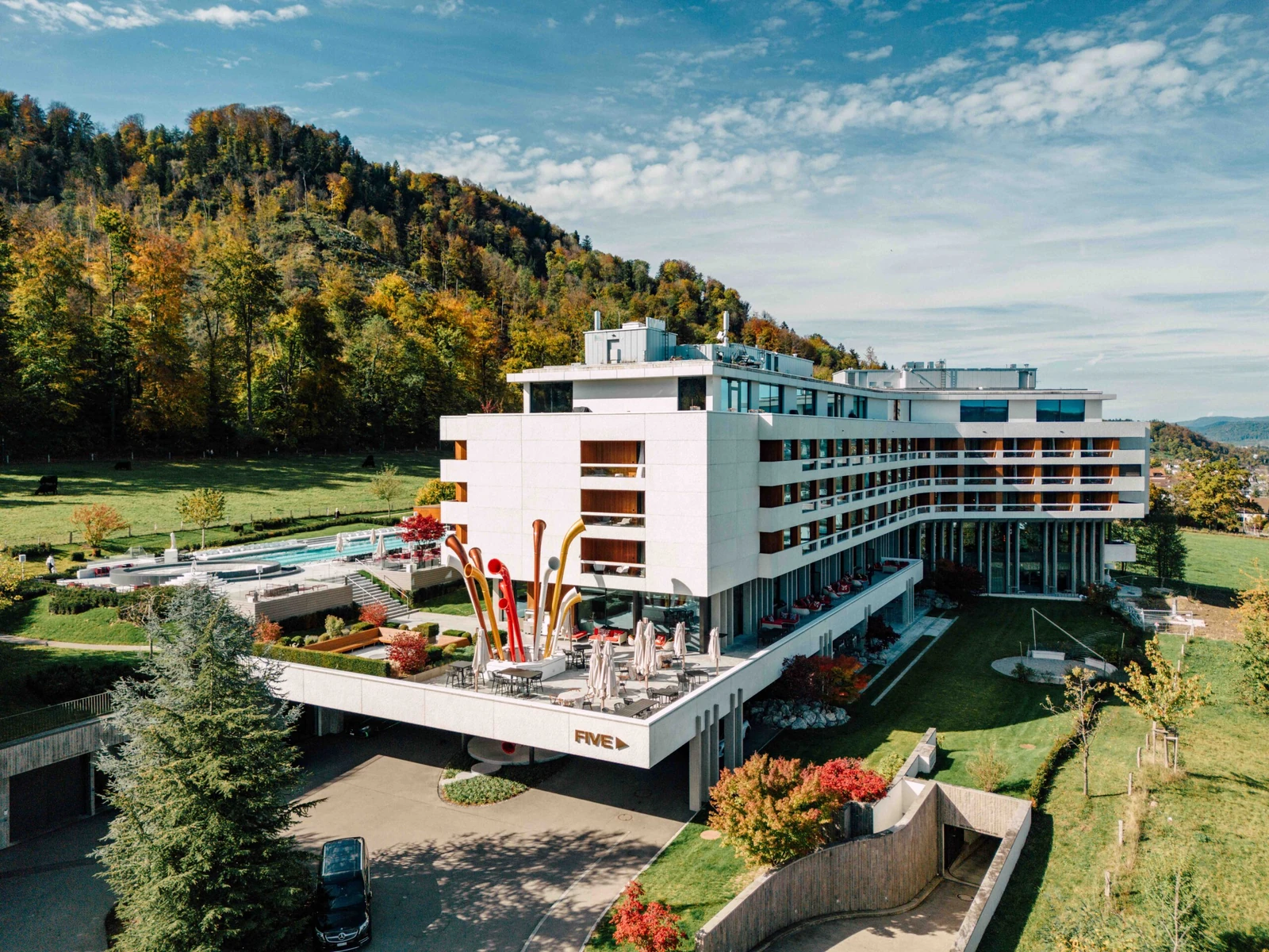 Elevated exterior view of the complete FIVE Zurich hotel in its hillside setting