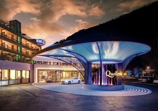 Illuminated Quellenhof entrance canopy and resort arrival in Passeier